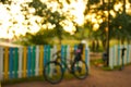 Defocus bycicle at colourful fence