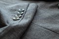 Ã Â¸ÂºBlurred defocus shot of formal black or dark grey wool suit fabric texture. with button decoration under light and shadow