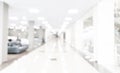 Blurred defocused bokeh background of exhibition hall or convention centre hallway. Business trade show modern white interior arch Royalty Free Stock Photo