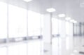 Blurred defocused bokeh background of exhibition hall or convention centre hallway. Business trade show modern white interior arch Royalty Free Stock Photo