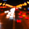 Blurred defocused car lights at night. Abstract colorful blurred background of night city with lights reflections Royalty Free Stock Photo