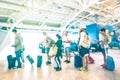 Blurred defocused people waiting in queue at airport terminal gate