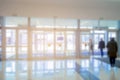 Blurred doors of a hospital with people coming in, blurred abstract medical backdrop