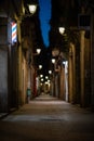 Blurred downtown alley at night with barbershop or hairdresser& x27;s sign on the wall Royalty Free Stock Photo