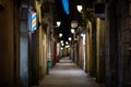 Blurred downtown alley at night with barbershop or hairdresser& x27;s sign on the wall Royalty Free Stock Photo