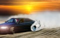 Blurred drift car on race track with smoke from burned tire
