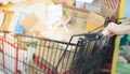 Blurred effect of female worker hands pushing pile of used cardboard packaging boxes in the Supermarket aisle with silver and Royalty Free Stock Photo