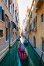 Blurred effect for a gondolier with tourists in a canal in Venice Royalty Free Stock Photo