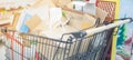 Blurred effect of pile of used cardboard packaging boxes in the Supermarket aisle with silver and black shopping trolley and Royalty Free Stock Photo