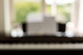 blurred electronic piano with notes and flowers in a vase