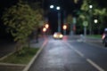 Blurred empty night street, taxi standing by traffic lights, defocused picture Royalty Free Stock Photo