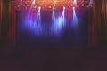 Blurred empty theatre stage with fun colourful spotlights, abstract image of concert lighting  illumination background Royalty Free Stock Photo