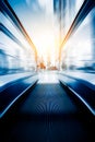 Blurred escalator toward modern skyscrapers