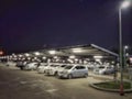 Blurred exterior view busy outdoor parking lots in modern shopping center. Royalty Free Stock Photo