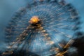 Blurred ferris wheel in motion at the amusement park, night illumination. Long exposure Royalty Free Stock Photo