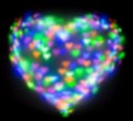 Blurred festive background with defocused colourful glitter formed a heart, bokeh in a shape of a heart. Original photographic