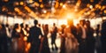 Blurred figures of people dancing in a hall with glowing bokeh lights capturing the warm festive atmosphere of a joyous Royalty Free Stock Photo