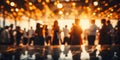 Blurred figures of people dancing in a hall with glowing bokeh lights capturing the warm festive atmosphere of a joyous Royalty Free Stock Photo