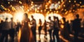 Blurred figures of people dancing in a hall with glowing bokeh lights capturing the warm festive atmosphere of a joyous Royalty Free Stock Photo