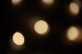 Blurred focus of circular bokeh lights in warm golden tone for abstract background. Seasons greetings, Merry Christmas Royalty Free Stock Photo