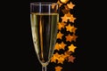 Blurred focus of a glass of sparkling wine with golden star shape bokeh lights