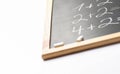 Blurred Fragment of Black Chalkboard with Hand Written Simple Mathematics Equations White Chalks. Back to School Concept Education Royalty Free Stock Photo