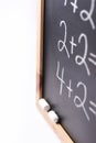 Blurred Fragment of Black Chalkboard with Hand Written Simple Mathematics Equations White Chalks. Back to School Concept Education