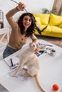 Blurred freelancer playing with oriental cat