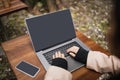 Blurred freelancer using laptop with blank