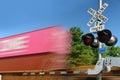 Blurred freight train containers speeding in motion at crossing gate Royalty Free Stock Photo