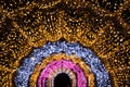 Blurred garland as arc or semicircle. City night light blur bokeh, defocused background. Holiday abstract pattern Royalty Free Stock Photo