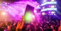 Blurred girl hands making video of summer festival concert with mobile phone - Crowd celebrating party event - Defocused image - Royalty Free Stock Photo