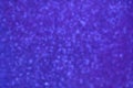 Blurred glittery texture of glitter in purple blue. Abstract Bokeh background.