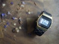 The blurred,Gold watch Black stainless steel strap On a dark wood  background Royalty Free Stock Photo