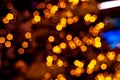 Blurred golden lights abstract background in the night, defocused dark glowing bokeh backdrop, magical yellow illuminated sparkle Royalty Free Stock Photo