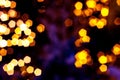 Blurred golden lights abstract background in the night, defocused dark glowing bokeh backdrop, magical yellow illuminated sparkle Royalty Free Stock Photo