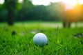 golf ball on tee in beautiful golf course at sunset background Royalty Free Stock Photo