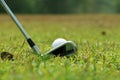 Blurred golf club and golf ball close up in grass field with sunset. Golf ball close up in golf coures Royalty Free Stock Photo