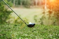 Blurred golf club and golf ball close up in grass field with sunset. Golf ball close up in golf coures Royalty Free Stock Photo