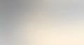 Blurred gradient background with soft transitions from gray to beige tones, creating a Royalty Free Stock Photo