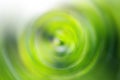 Blurred gradient radial motion dark and light green background. Mixed circular texture