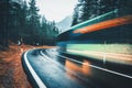 Blurred green bus on the road in autumn forest in rain Royalty Free Stock Photo