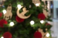 Blurred green christmas tree background with horse bauble, red m Royalty Free Stock Photo