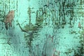 Blurred green textured background. Old green peeling paint on a wooden surface with cracks. Royalty Free Stock Photo