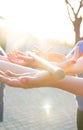 Blurred hands hold a blurred, wooden stick. teambuilding activity with a stick and hands. colleagues. rays of the sun fall, light