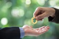 Blurred Hands of two businessmen are trading coin of bitcoin. A symbolic coins of bitcoin. electronic money exchange