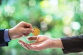 Blurred Hands of two businessmen are trading coin of ethereum. A symbolic coins of ethereum. electronic money exchange, Royalty Free Stock Photo