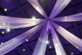 Blurred hanging curtains purple color in wedding hall room, decorative curtains on the ceiling interior hall in night