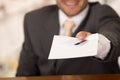 Blurred happy smiling receptionist in hotel giving key to guest and papers to sign Royalty Free Stock Photo