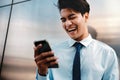 Blurred of a Happy Young Businessman Using Mobile Phone in the Urban City. Lifestyle of Modern People. Front View Royalty Free Stock Photo